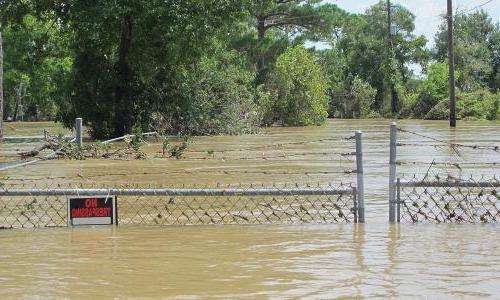 Gate to toxic waste site almost submerged by floodwaters